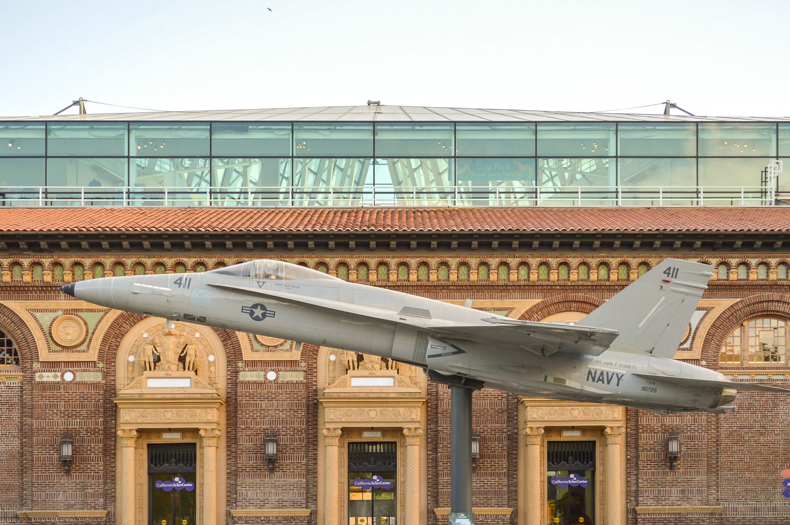 1950's era grey plane propped up outside a museum outside