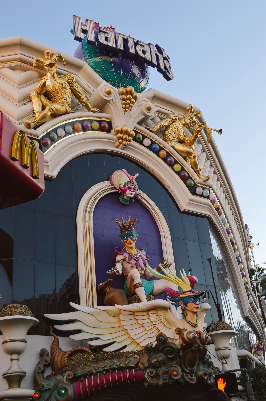 exterior of the Harrahs hotel and casino in Las Vegas with purple wall and gold decor