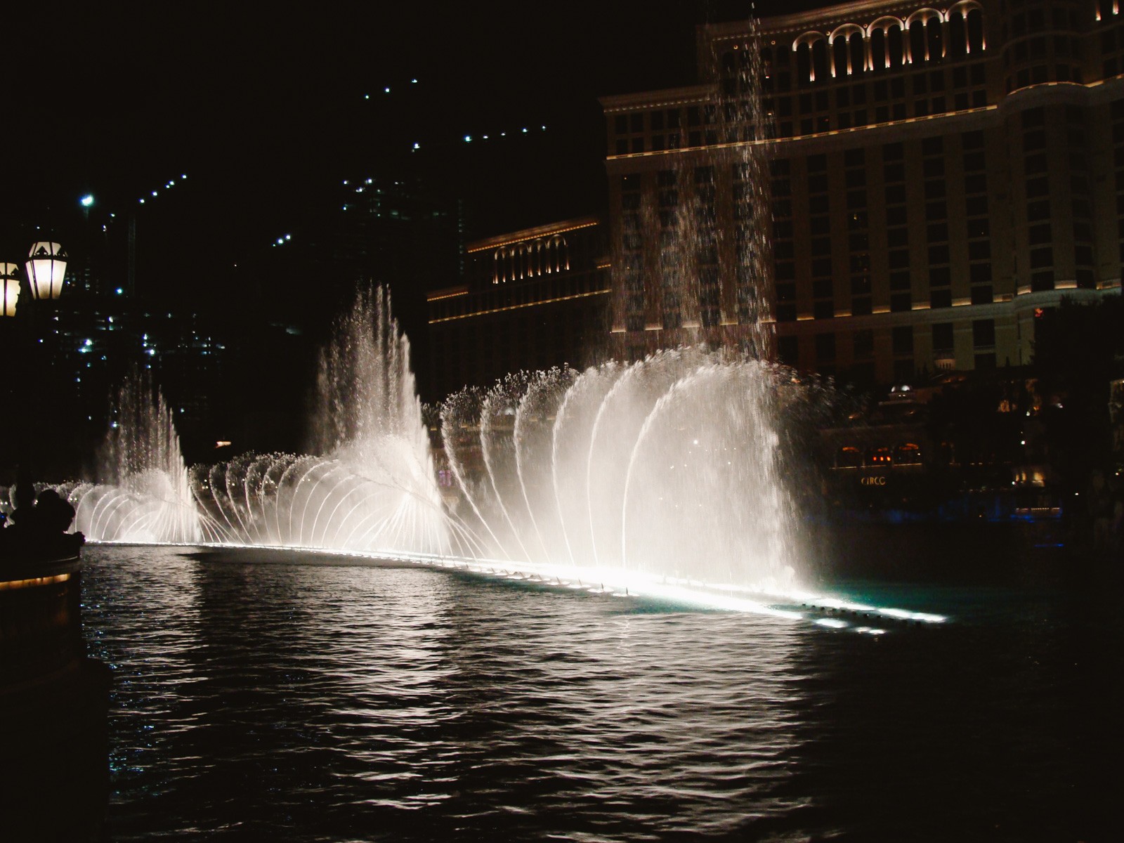 fountain show at night on a man made lake
