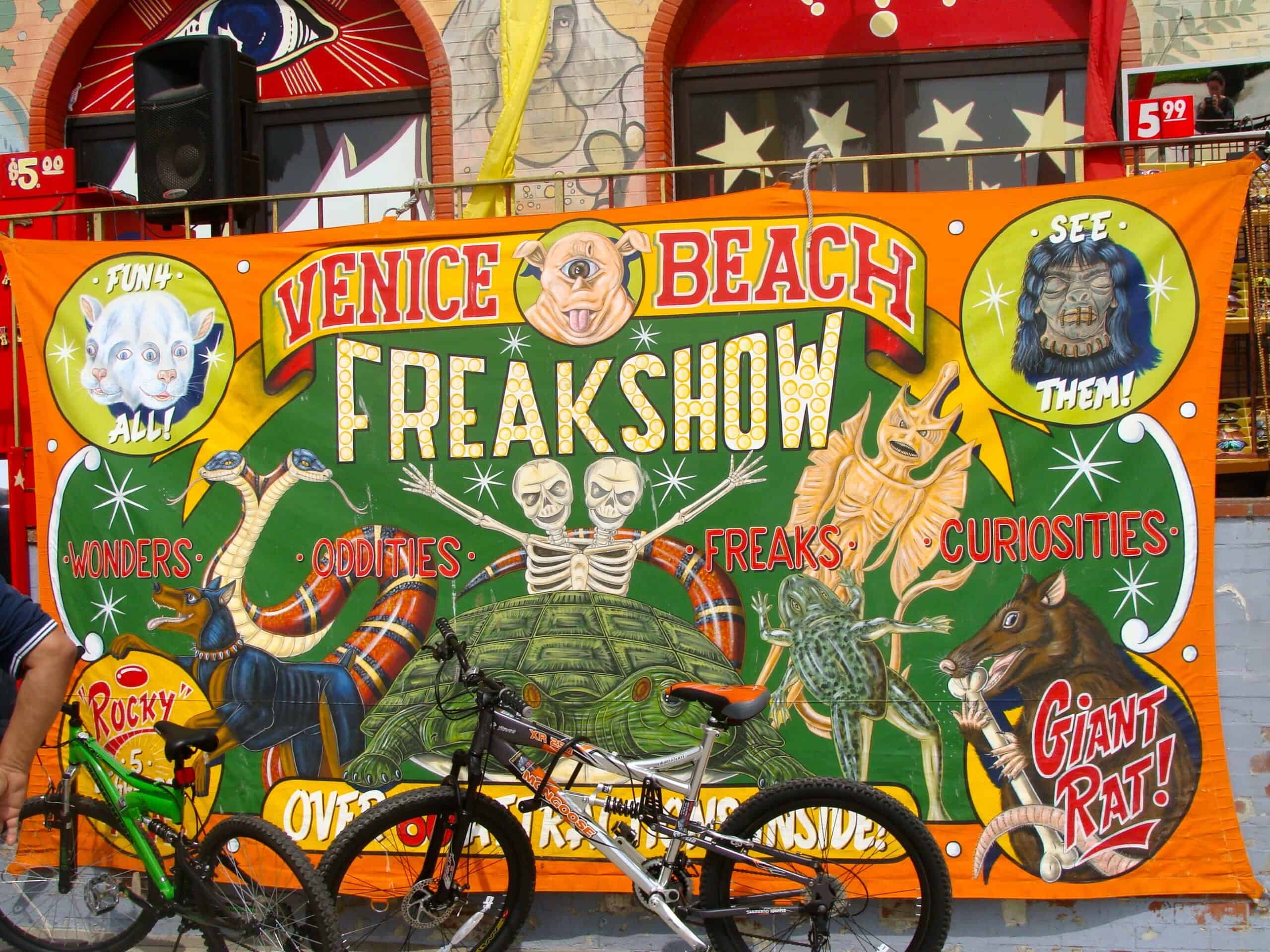 poster for Venice Beach Freakshow in orange and green with oddities on the front