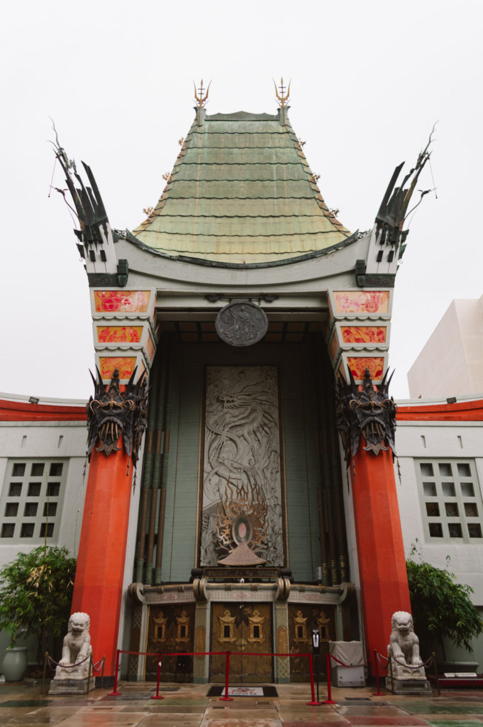 TCL Chinese Theatre in Hollywood California with red pillars and a green top with Chinese architecture