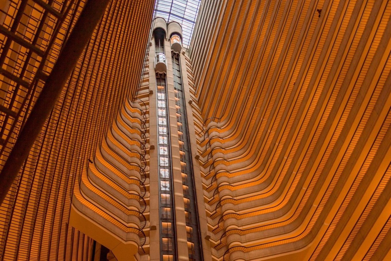 view of a hotel interior from a lower level looking up with elevators in the middle and other worldly architecture in Atlanta