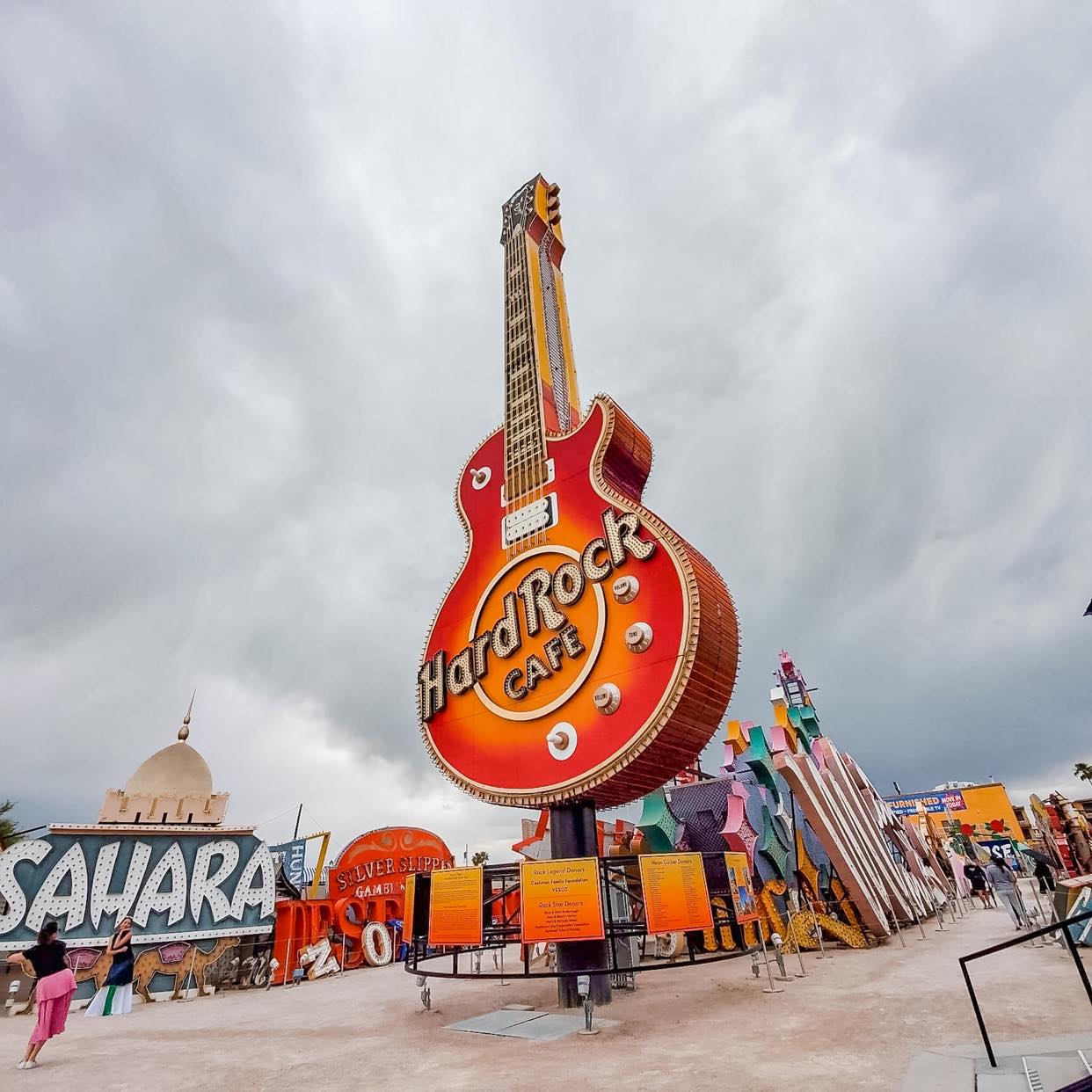 hard rock hotel and sahara hotel neon signs in a neon sign graveyard at the neon museum in las vegas on a cloudy day