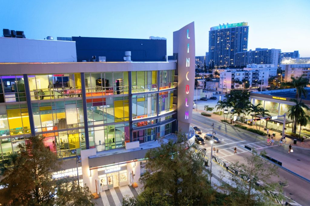 building during twilight with Lincoln vertically spelled on the side in rainbow color, with colorful windows on the side