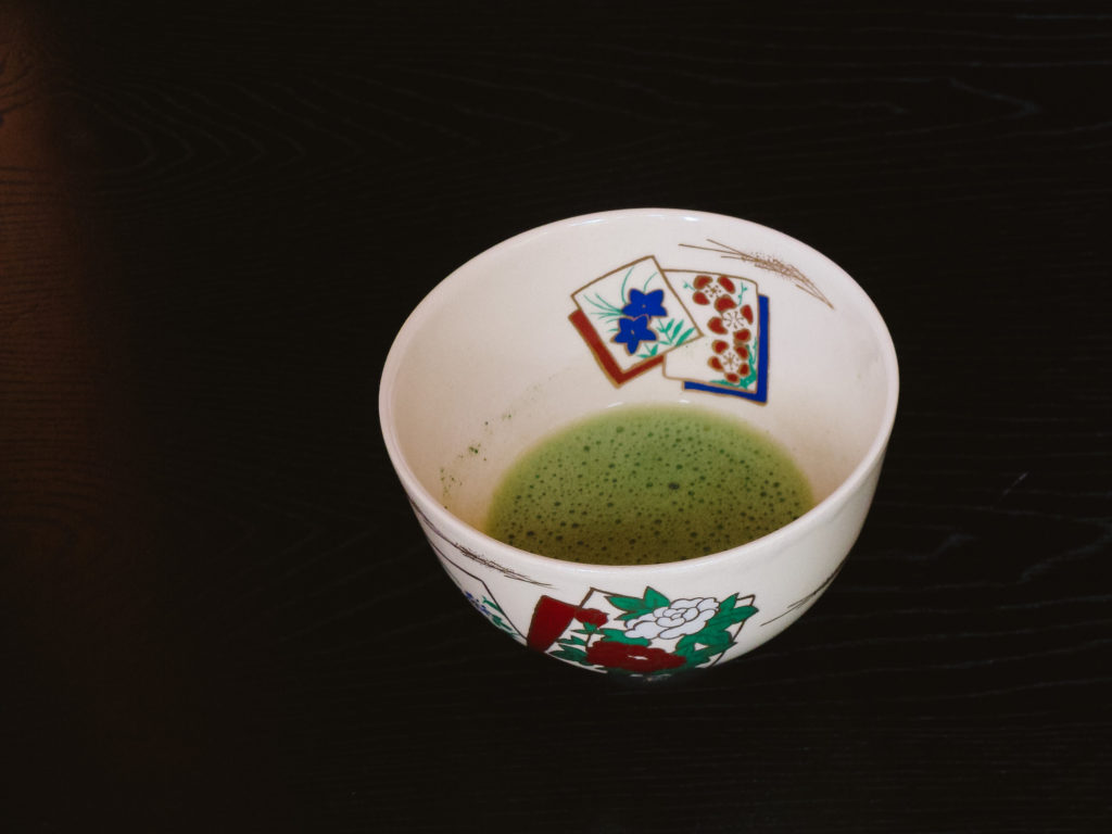 Japanese tea cup filled with green matcha tea