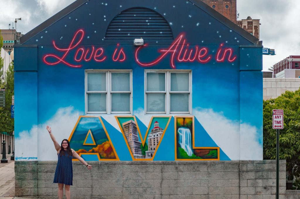 Asheville street art that says "Love is Alive in AVL"