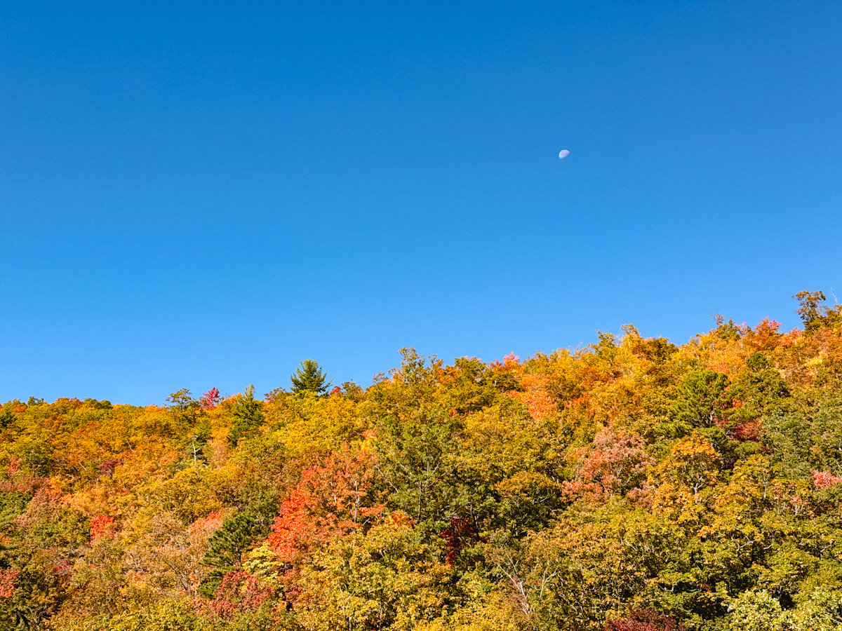 View of the Great Smoky Mountains in the fall under a moon during the day