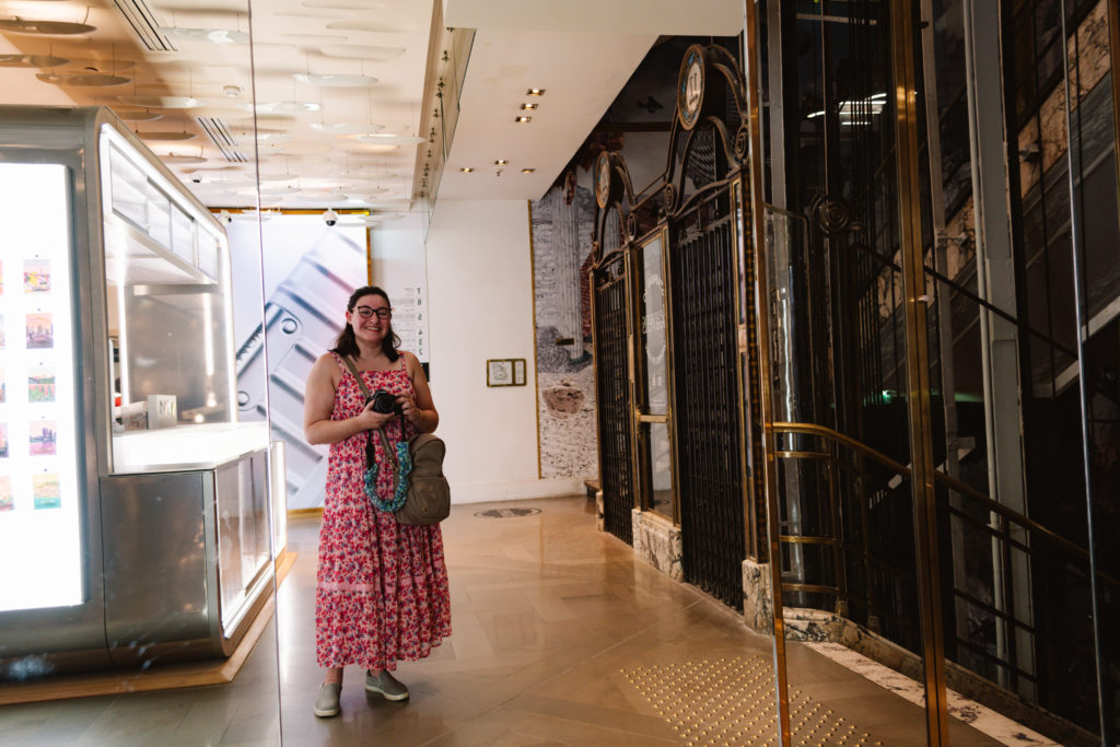 mirror selfie with DSLR camera of woman in pink dress