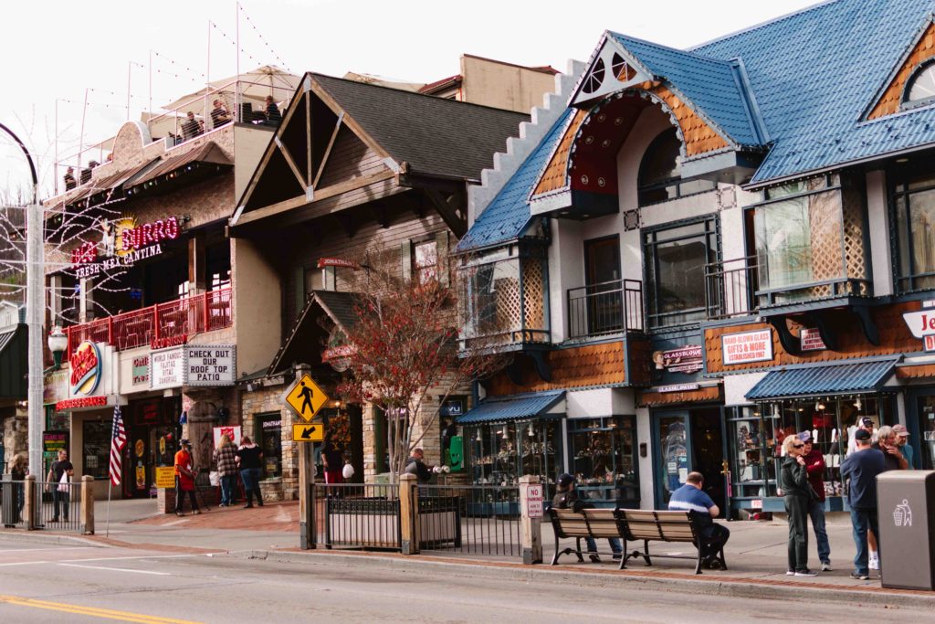 street of Gatlinburg Tennessee with multiple restaurants and shops in European style buildings