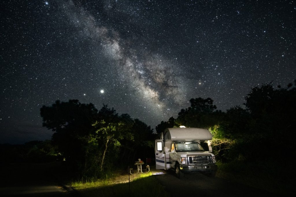 RV at night parked with the Milky Way above