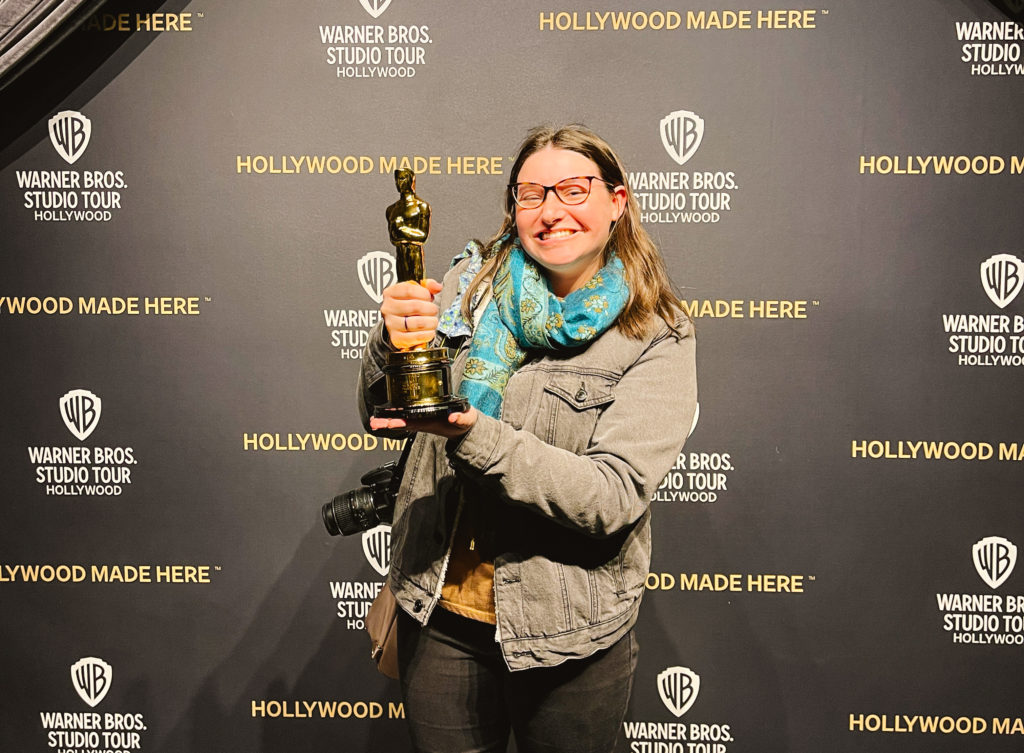 Woman holding an Academy Award Oscar at Warner Brothers Studio Tour in Burbank California