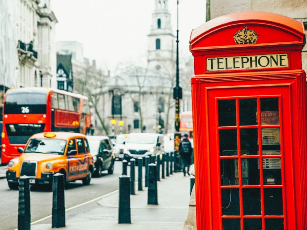Telephone booth in London with city streets in the background on the left