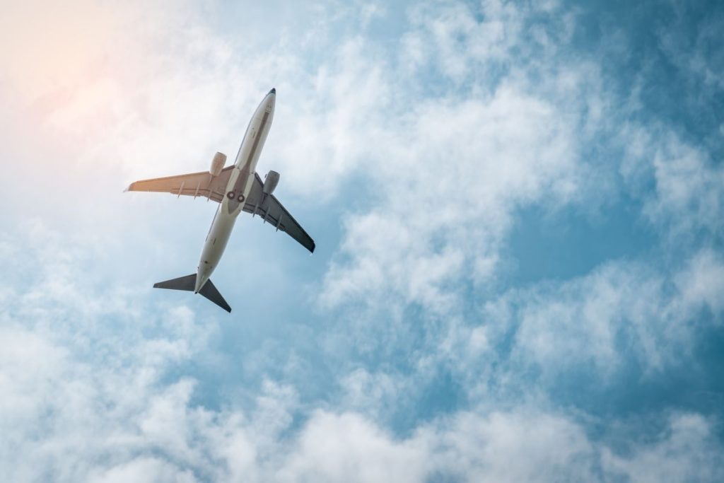 view of airplane from underneath during takeoff