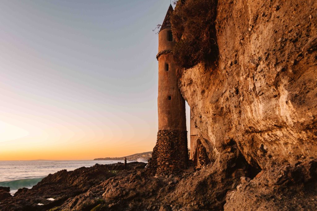 Pirate tower during sunset in Laguna Beach sitting on a cliffside with the beach to the left