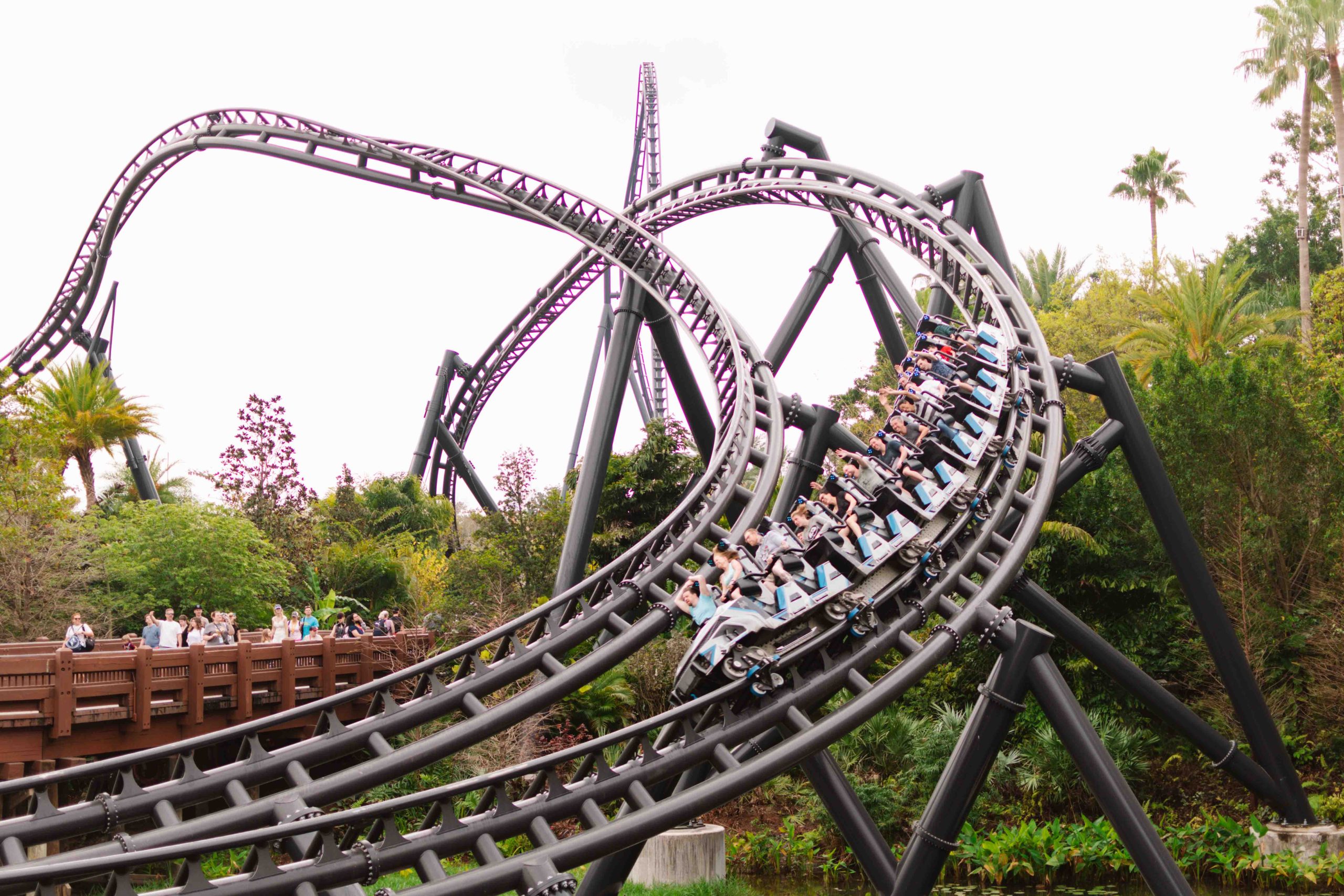 roller coaster car going over a track in a theme park in Florida