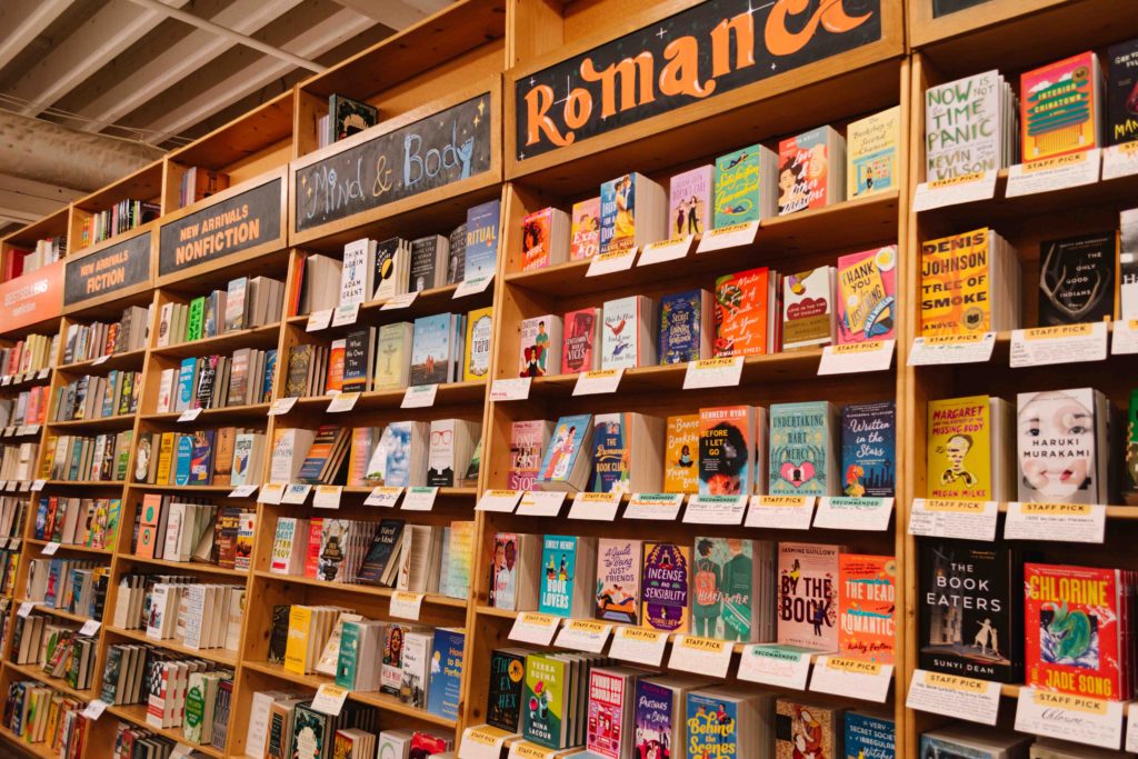 Shelves of books with handwritten notes about each one