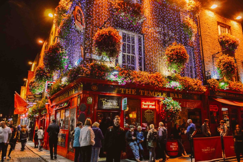 Temple Bar Pub at night lit up with flowers and walls of string lights