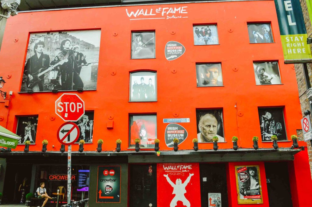 Red wall with cutouts of famous Dublin Ireland musicians