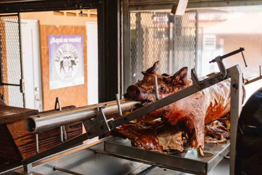 Roasting pork on a spit in a food stall in Puerto Rico