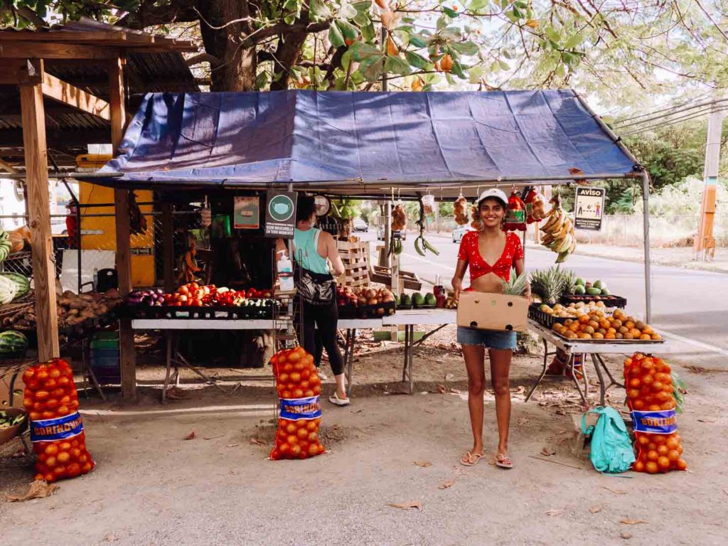 woman buying some produce from a street vendor in Puerto Rico