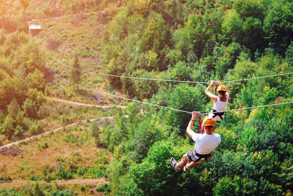 Two people zip-lining in Puerto Rico forest