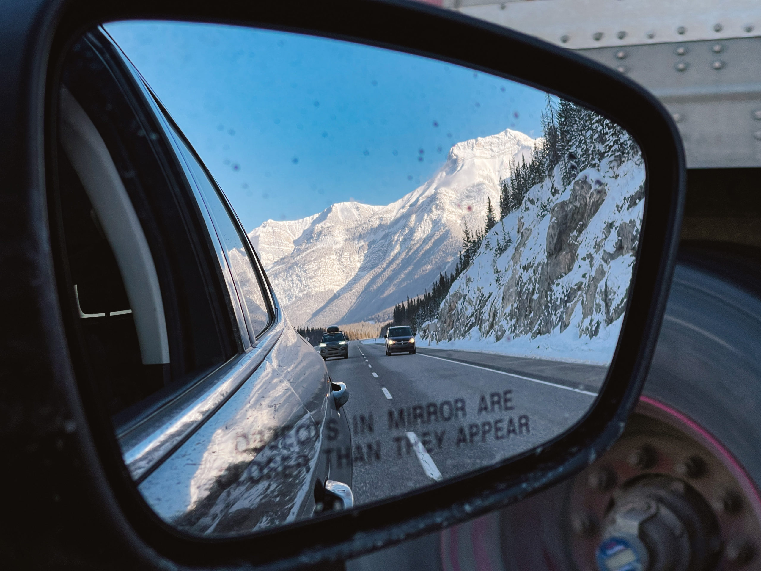 View of side mirror with Banff Canadian Rockies behind