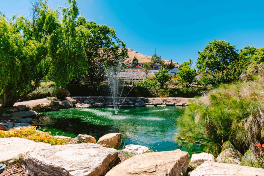 Madonna Inn Secret Garden fountain with hotel in the background