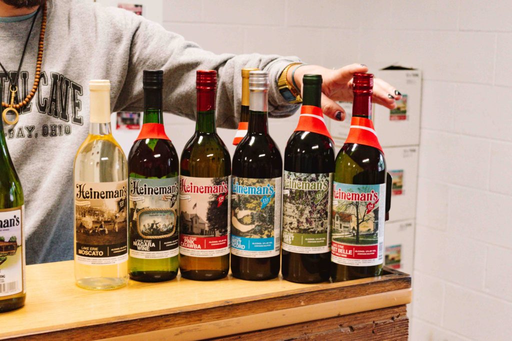 Bottles of wine on a bar in a line from most sweet to most dry.