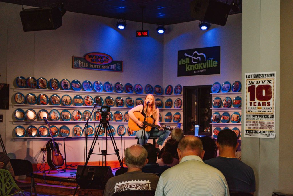 View of a female musician performing live in front of a radio audience
