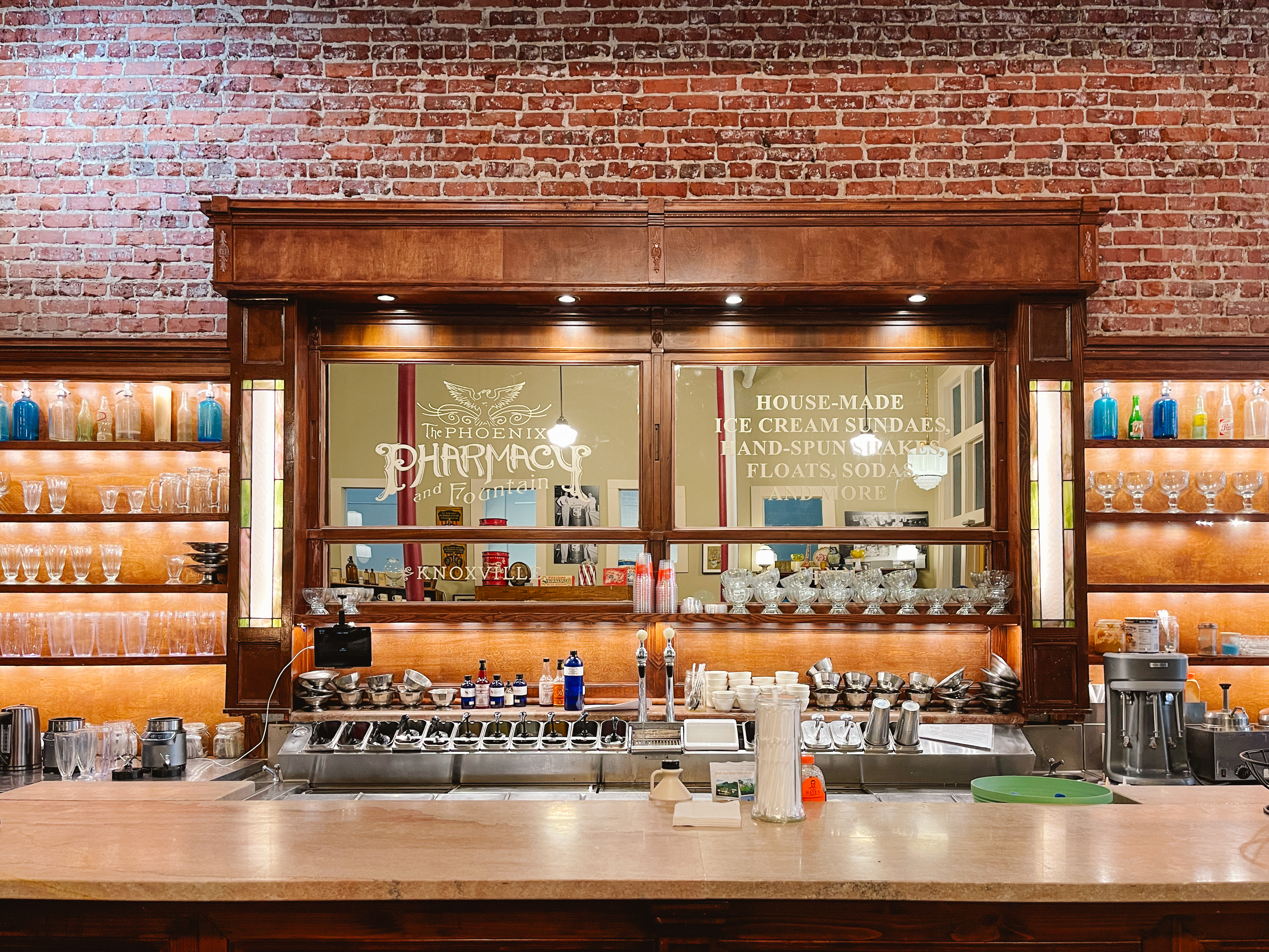 View of a historic soda fountain in Knoxville with a brick wall behind