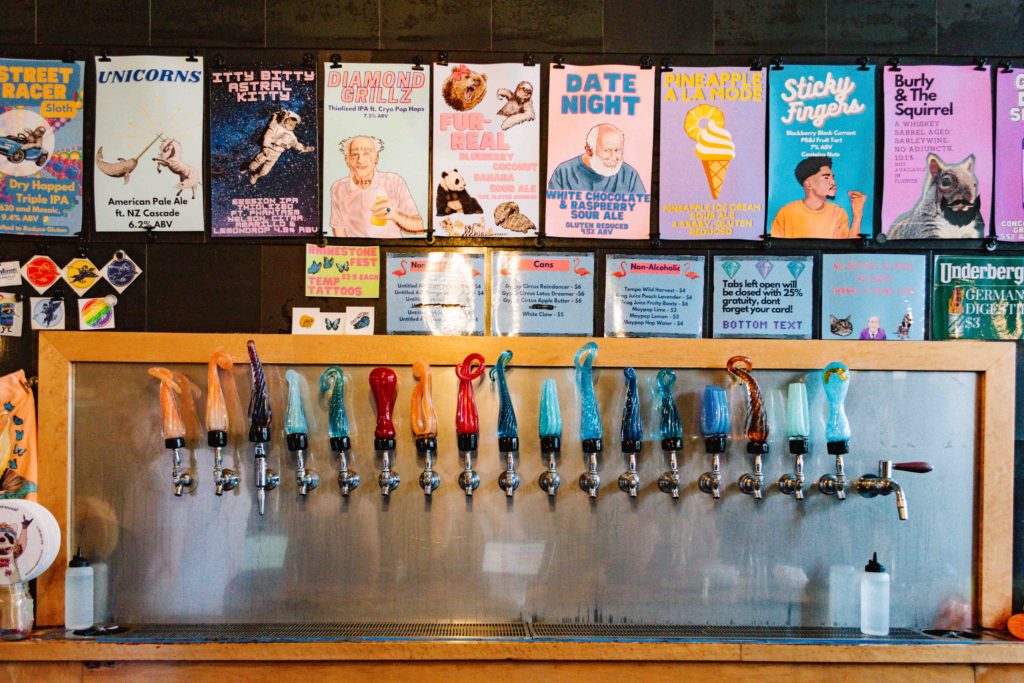 View of beer taps in a brewery with hand made blown glass taps.