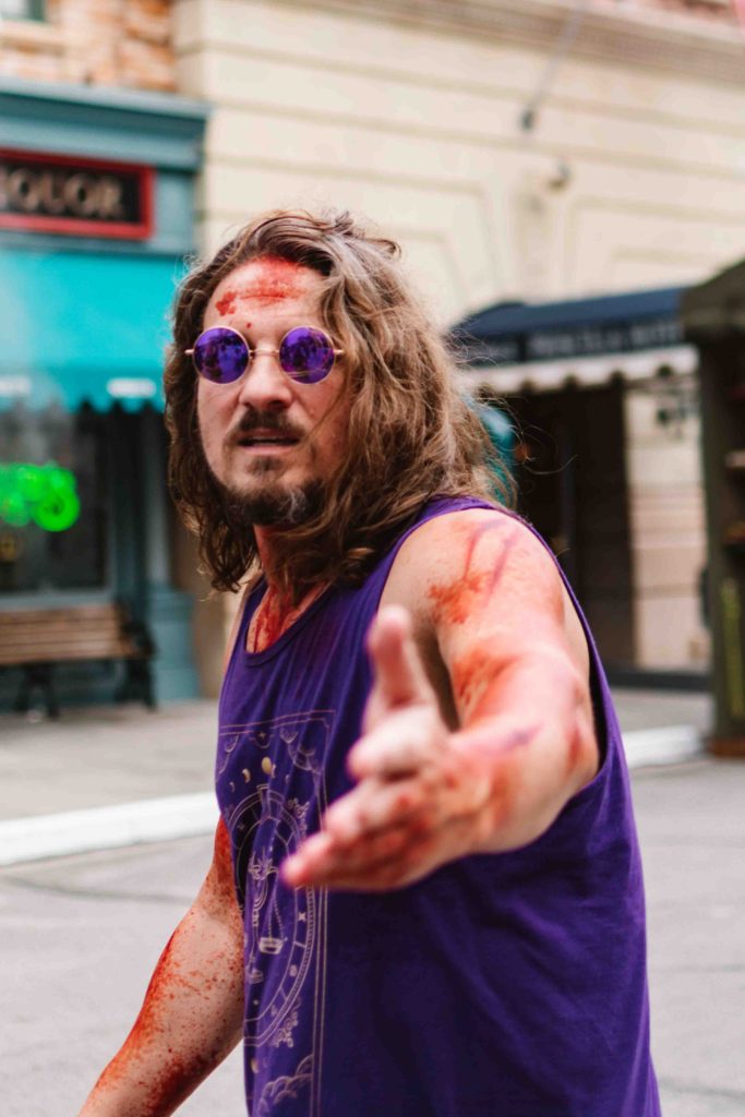 Halloween scare actor in Universal Orlando dressed like a 1969 vampire.
