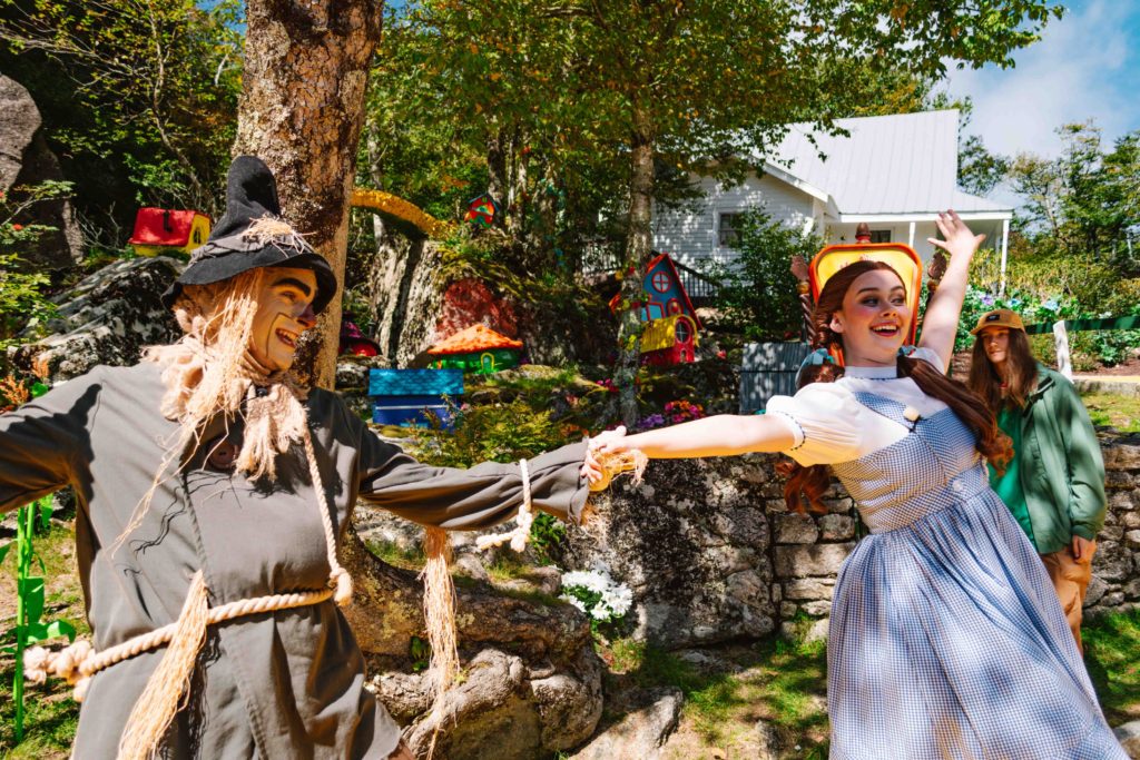 Scarecrow and Dorothy dancing near Munchkinland