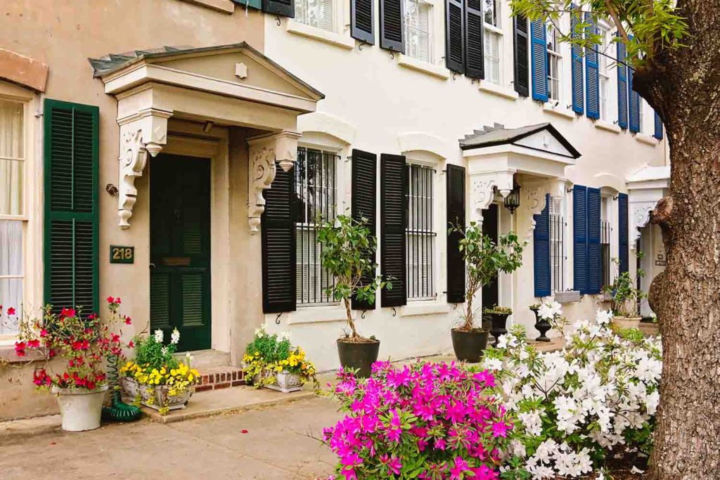 View of historic row houses in Savannah Georgia with spring azaleas in full bloom in springtime making this a great spring getaway