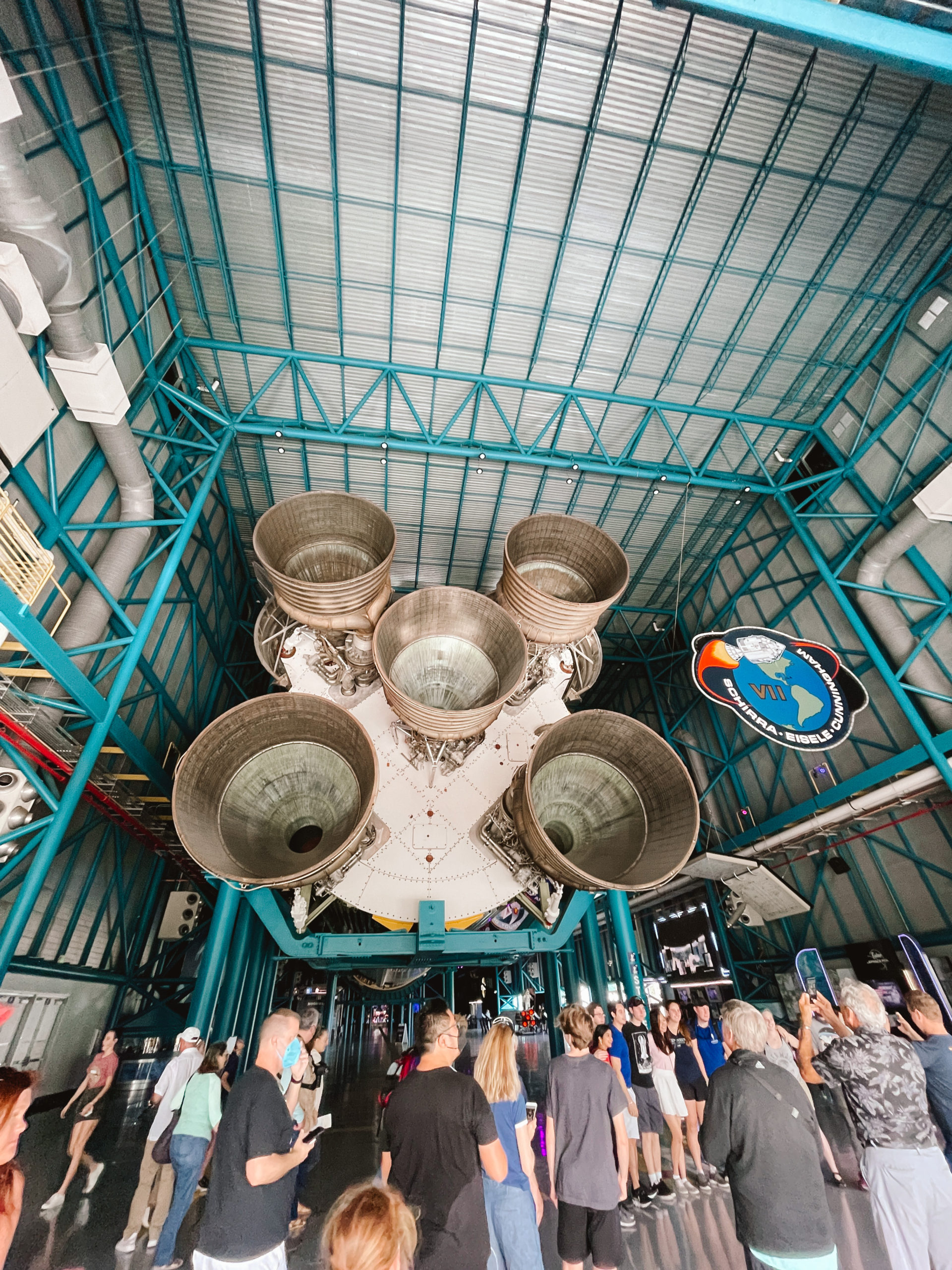 Saturn V rocket view from the back with five engine exhausts in a large warehouse museum building in Florida, as part of the Apollo Saturn V Center at Kennedy Space Center
