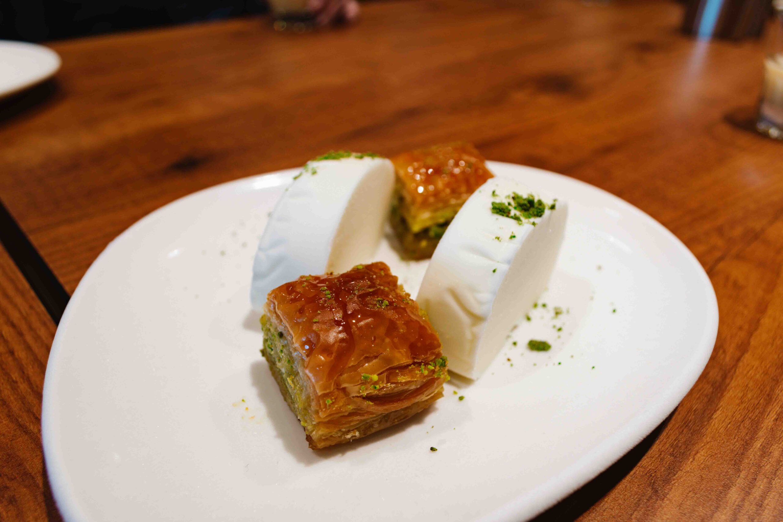 Slices of baklava and Turkish vanilla ice cream on a plate to taste.