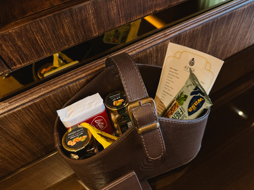 Basket of pantry snacks and cost menu in hotel room