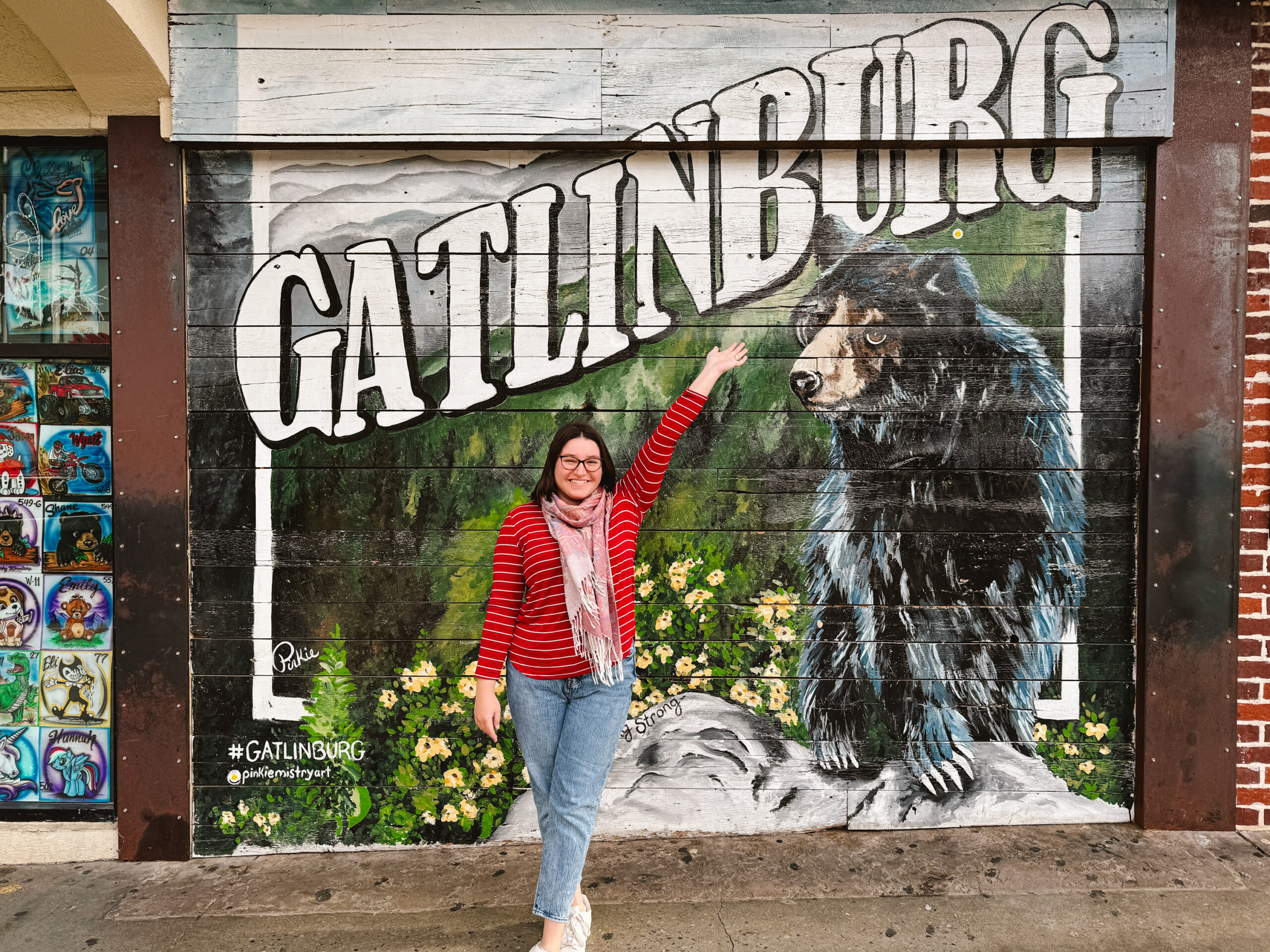 Woman posing in front of Gatlinburg mural