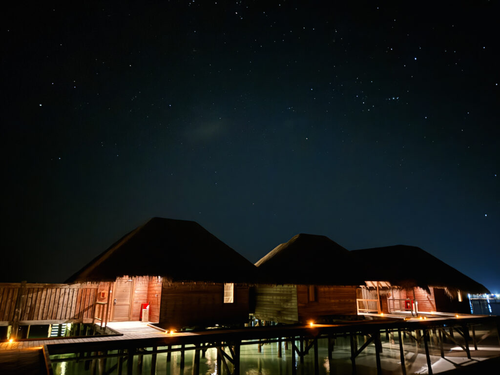 Stars at night over the overwater bungalows in the Maldives