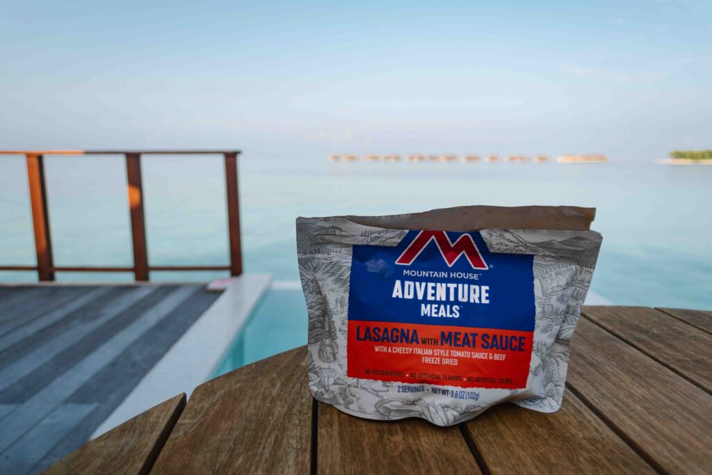 Mountain House Adventure Meals Lasagna and meat sauce on a table on Maldives resort patio
