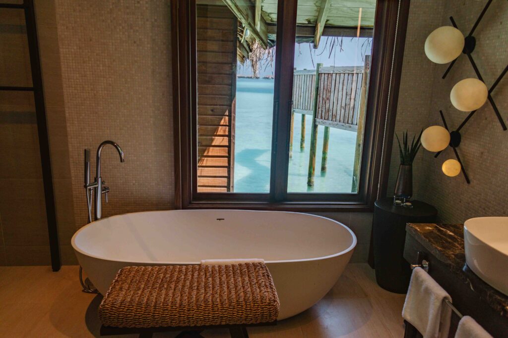 Maldives bathroom with large tub overlooking the turquoise water