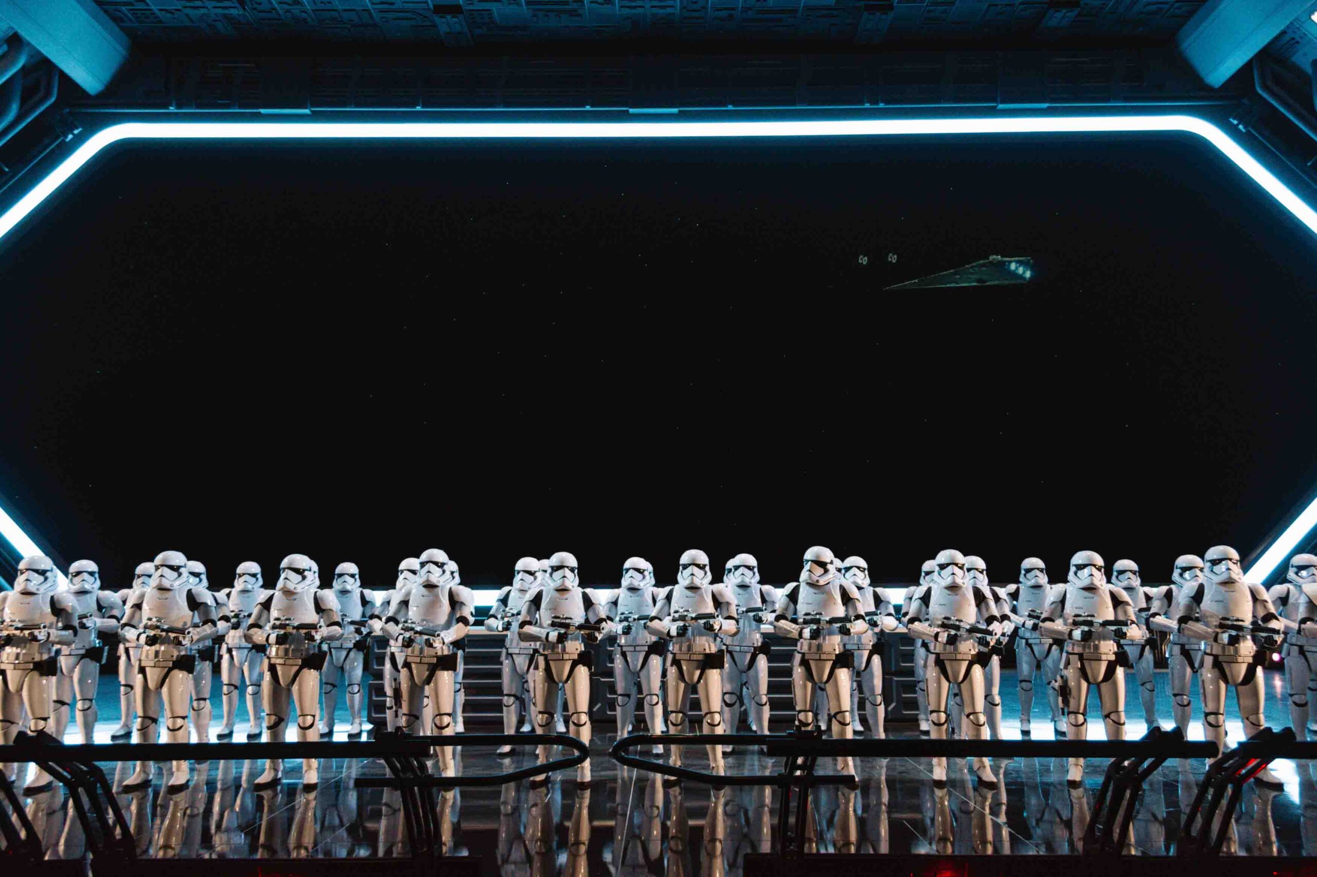 Inside a starship destroyer from Star Wars with storm troopers lined up to greet you on Rise of the Resistance ride