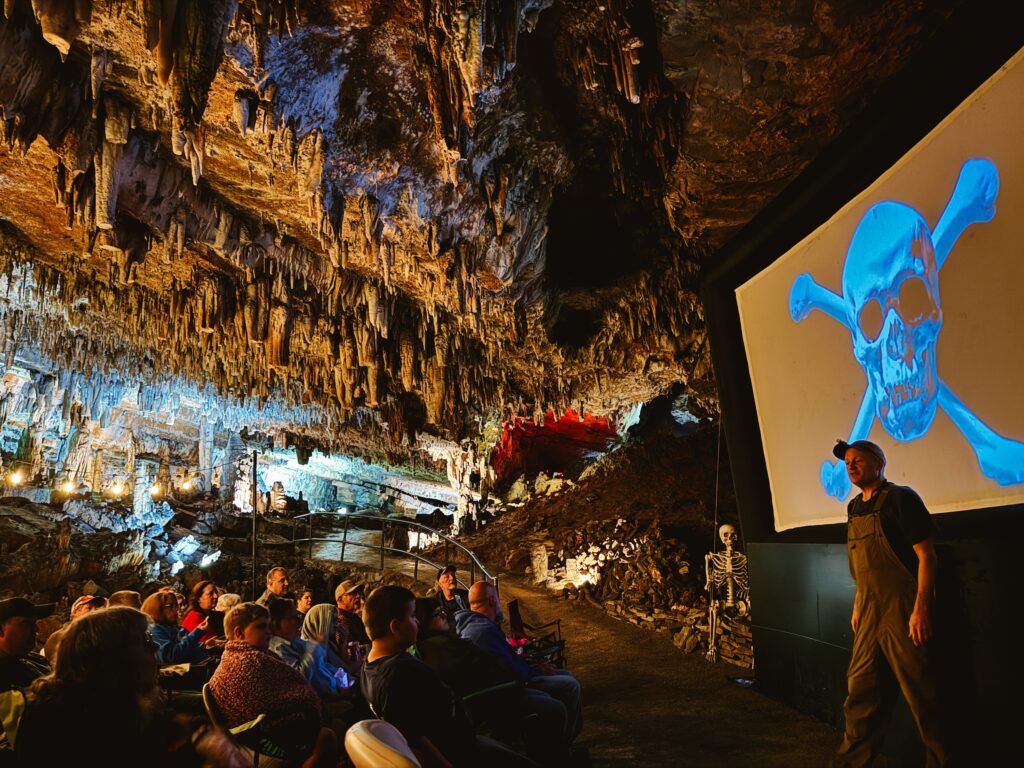 Showing movies in a cave in Knoxville with The Goonies on the screen and stalactites hanging overhead