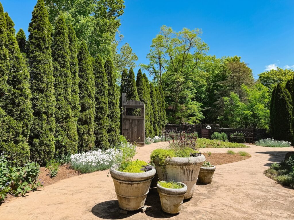 View of paved, maintained part of the Knoxville Botanical Gardens in spring on a sunny day