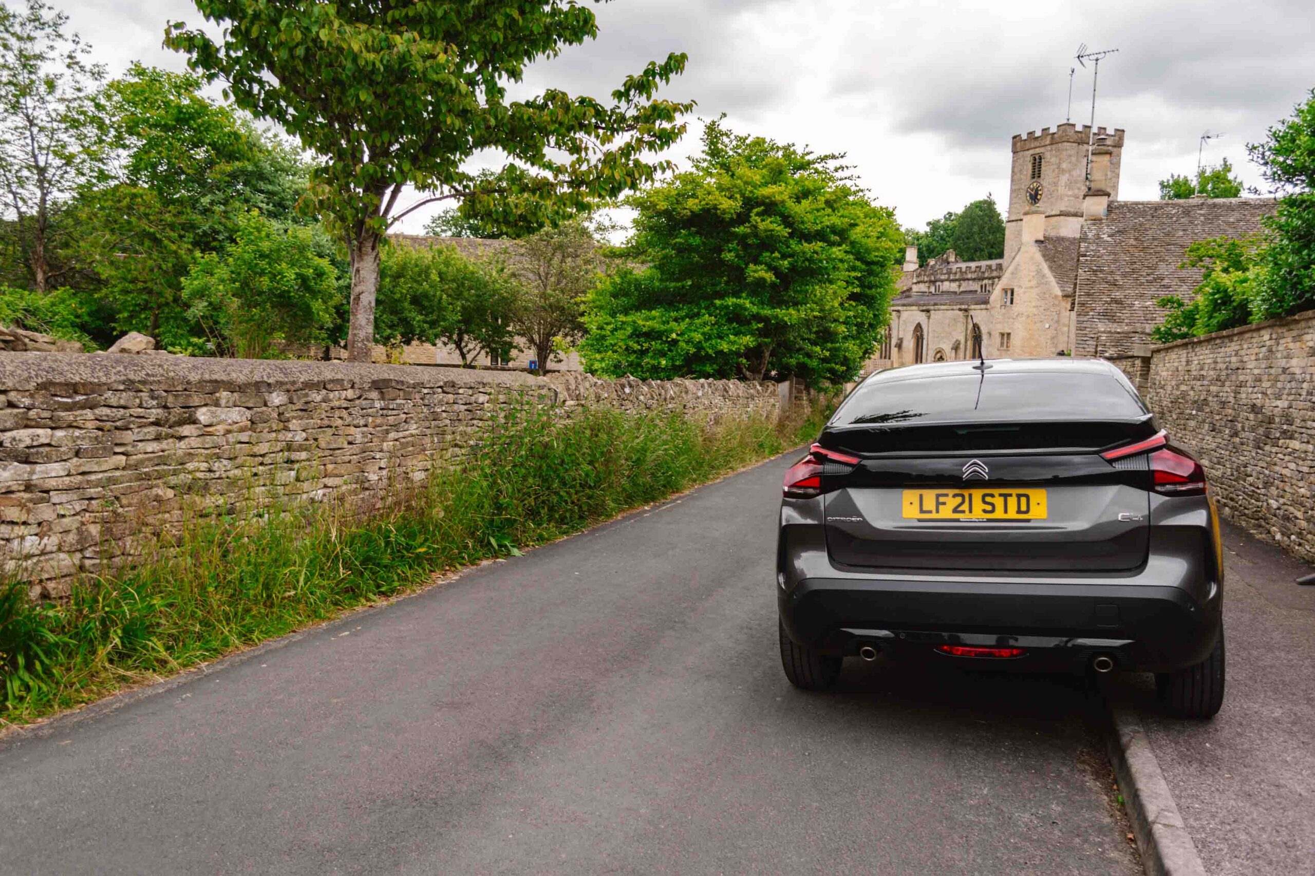 Street parking in the UK in the Cotswolds on the curb.
