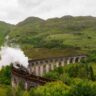 Jacobite Steam Train (aka the red and black Hogwarts Express train) crossing over the Glenfinnan Viaduct in the morning