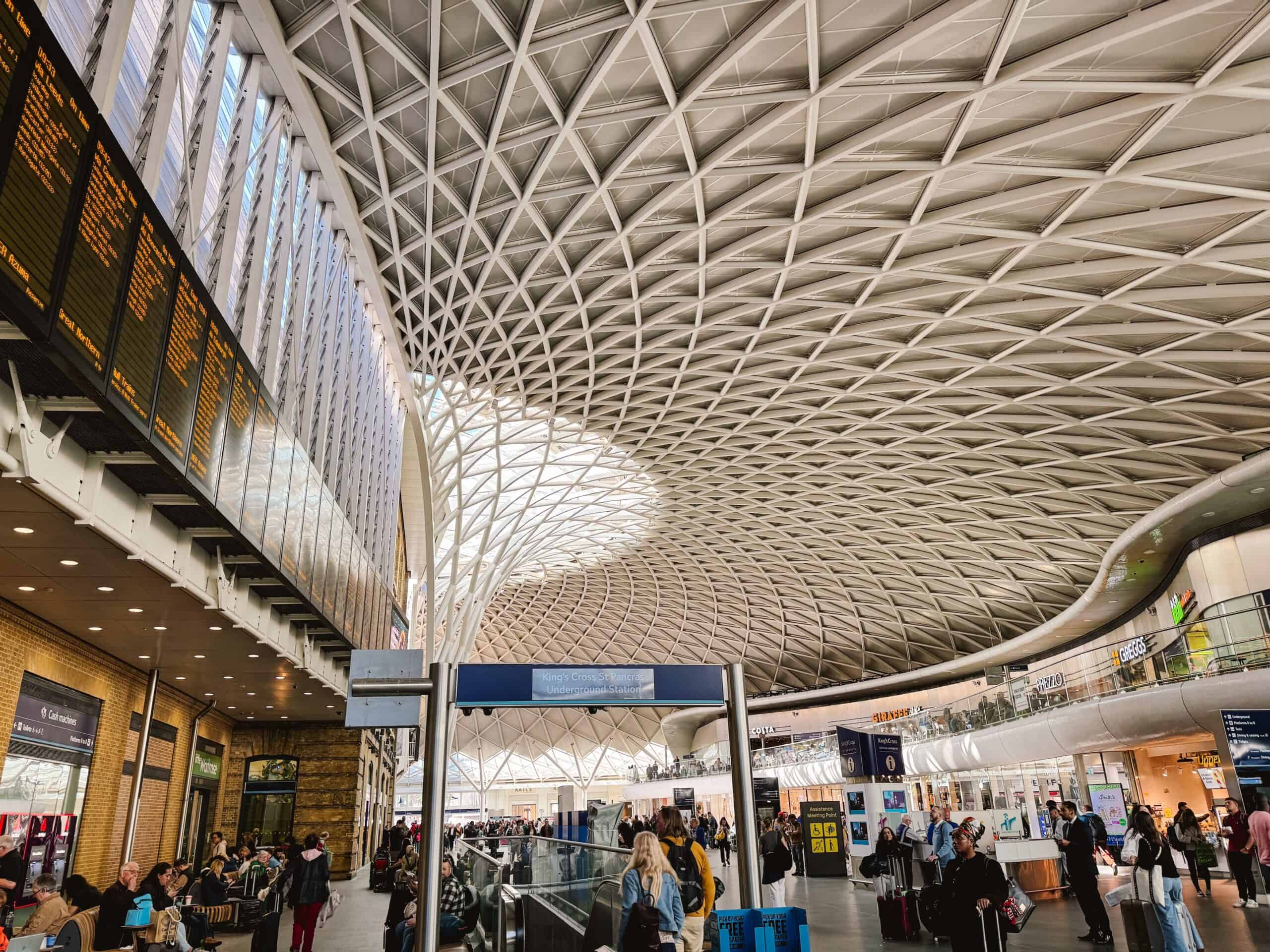 London's King Cross Station interior during the morning with time table board to the left