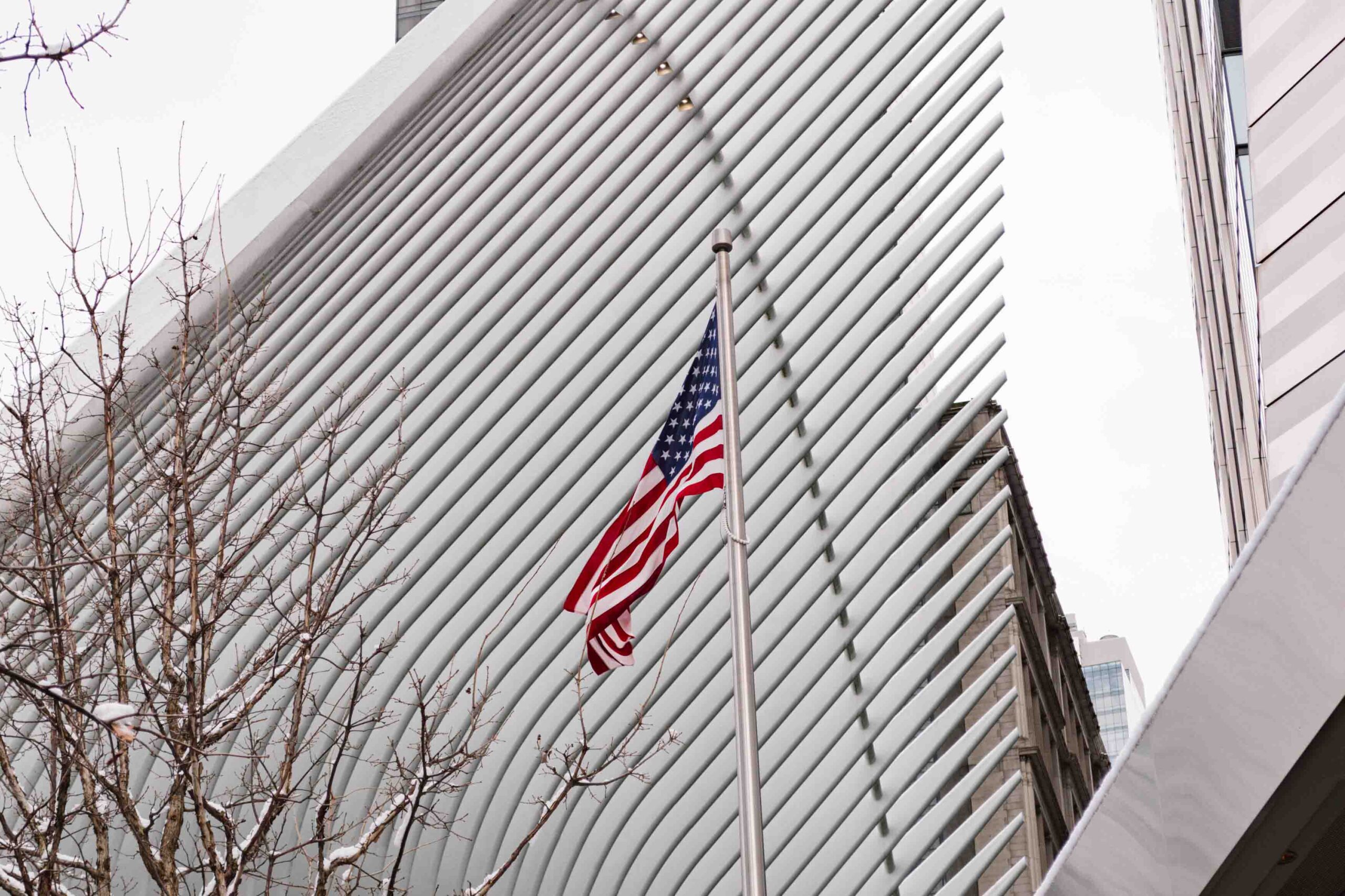 Exterior of 9/11 Memorial Museum with the American flag waving