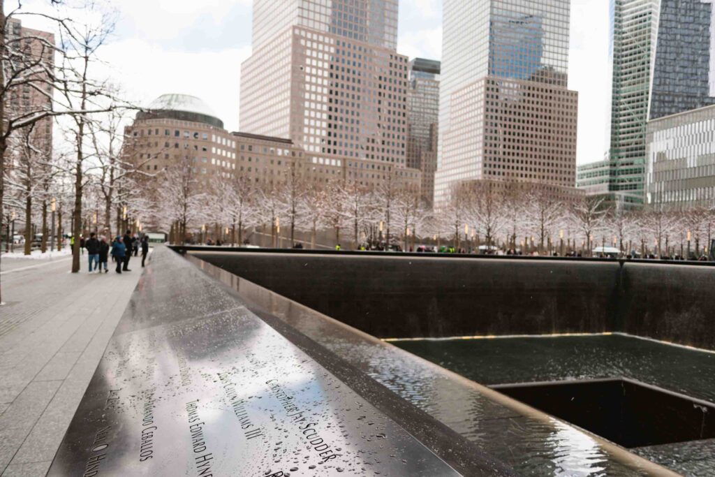9/11 memorial with names of those lost on the outside on a rainy winter day