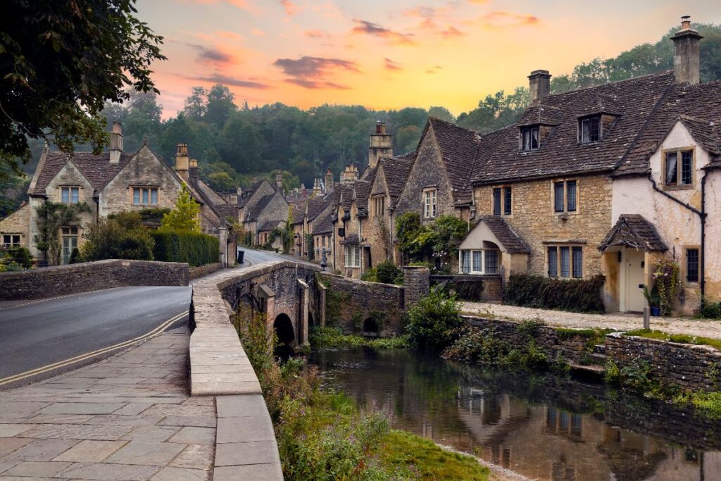 View of beautiful homes in Castle Combe at sunset